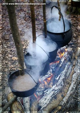 Large cast iron pot being used to reduce sugar maple sap to maple